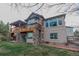 Stunning two-story home with stone accents, a large deck, and well-manicured lawn at 3535 Medallion Rd, Castle Rock, CO 80104