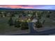 Beautiful home with manicured lawn, mature trees and mountain views at sunset at 3535 Medallion Rd, Castle Rock, CO 80104
