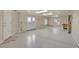 Spacious garage with painted concrete floor, double doors to the exterior, and a service door at 3535 Medallion Rd, Castle Rock, CO 80104