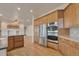Bright kitchen with stainless steel appliances and generous cabinet space at 3535 Medallion Rd, Castle Rock, CO 80104