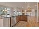 Kitchen island features stone counter tops, a stainless steel dishwasher, and hardwood floors at 3535 Medallion Rd, Castle Rock, CO 80104