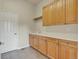 Functional laundry room with ample cabinet space and tile flooring at 3535 Medallion Rd, Castle Rock, CO 80104