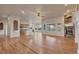 Open-concept living room with a stone fireplace and hardwood floors at 3535 Medallion Rd, Castle Rock, CO 80104