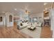 Spacious living room with hardwood floors, stone fireplace, and tons of natural light at 3535 Medallion Rd, Castle Rock, CO 80104
