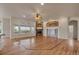 Bright and airy living room with hardwood floors, stone fireplace, and large windows at 3535 Medallion Rd, Castle Rock, CO 80104