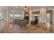 Open living room featuring a stone fireplace, hardwood floors, and natural lighting at 3535 Medallion Rd, Castle Rock, CO 80104