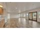 Bright living room featuring tile floors, recessed lighting, and a wooden-framed glass patio door at 3535 Medallion Rd, Castle Rock, CO 80104