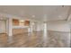 Open living room featuring light wood floors, recessed lighting, and a conveniently located wet bar at 3535 Medallion Rd, Castle Rock, CO 80104