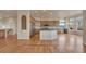 Spacious kitchen flows to open living area; note the hardwood floors and view at 3535 Medallion Rd, Castle Rock, CO 80104