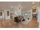 Spacious living room with fireplace, hardwood floors, and an open layout to the kitchen at 3535 Medallion Rd, Castle Rock, CO 80104