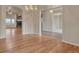 Open-concept living room featuring hardwood floors and elegant chandelier lighting at 3535 Medallion Rd, Castle Rock, CO 80104