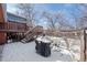 Snowy backyard with a deck, stairs, and grill, creating an inviting outdoor space for year-round enjoyment at 255 Iroquois Dr, Boulder, CO 80303