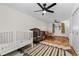 Expansive bedroom featuring two cribs, ceiling fans, and a cozy seating arrangement at 255 Iroquois Dr, Boulder, CO 80303