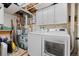 Well-equipped laundry room with washer, dryer, and storage cabinets for efficient organization and convenience at 255 Iroquois Dr, Boulder, CO 80303