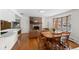 Open-concept living room featuring hardwood floors, a brick fireplace, and a large bay window with natural light at 255 Iroquois Dr, Boulder, CO 80303