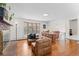 Bright living room boasts hardwood floors, a bay window, a brick fireplace, and cozy seating at 255 Iroquois Dr, Boulder, CO 80303