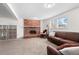 Inviting living room with a brick fireplace, carpeted floor, and comfortable brown leather sofa at 255 Iroquois Dr, Boulder, CO 80303