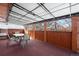 Enclosed patio with table and chairs, providing a relaxing outdoor space with protection from the elements at 255 Iroquois Dr, Boulder, CO 80303