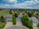 An aerial view of a neighborhood with well-maintained lawns and mature trees at 9079 Garnet St, Highlands Ranch, CO 80126