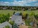 An aerial view of homes and lawns backing up to a green field at 9079 Garnet St, Highlands Ranch, CO 80126