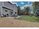 Backyard featuring a large patio with a dining set, grill, and lush greenery, perfect for enjoying outdoor living and dining at 9079 Garnet St, Highlands Ranch, CO 80126