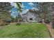 Expansive backyard with a well-maintained lawn and a spacious patio, perfect for outdoor entertaining and relaxation at 9079 Garnet St, Highlands Ranch, CO 80126