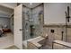 Beautiful bathroom featuring a large, tiled shower with glass door and a built in bench at 9079 Garnet St, Highlands Ranch, CO 80126