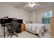Bright bedroom with carpet flooring, featuring a desk area and a well-lit window view at 9079 Garnet St, Highlands Ranch, CO 80126