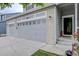 Close-up of a well-maintained two-car garage with decorative windows and a landscaped front yard, offering both style and functionality at 9079 Garnet St, Highlands Ranch, CO 80126