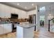 Well-lit kitchen with stainless steel appliances, a center island and an eating area with a skylight at 9079 Garnet St, Highlands Ranch, CO 80126