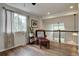 Cozy loft area with hardwood floors, a comfortable leather chair, and a large window providing natural light at 9079 Garnet St, Highlands Ranch, CO 80126