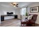 Inviting office space with dark wood floors, built-in desk area, comfortable leather chair, and lots of natural light at 9079 Garnet St, Highlands Ranch, CO 80126