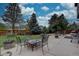 Spacious patio with a fire pit and multiple seating areas, ideal for entertaining and enjoying the outdoors in comfort and style at 9079 Garnet St, Highlands Ranch, CO 80126