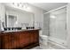 Modern bathroom with a double vanity, large shower, and dark wood cabinets at 12713 Leyden St # F, Thornton, CO 80602