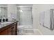 Clean bathroom with a large shower, single vanity, and updated fixtures at 12713 Leyden St # F, Thornton, CO 80602