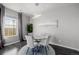 Bright dining area with glass table and modern light fixture at 12713 Leyden St # F, Thornton, CO 80602