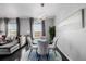 Dining area with glass table, four chairs, and modern decor at 12713 Leyden St # F, Thornton, CO 80602