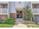 Inviting condo building entrance featuring brick accents and well-maintained landscaping at 7665 E Eastman Ave # 106A, Denver, CO 80231