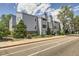 Light blue condo building with well-kept landscaping, charming balconies, and inviting sidewalk creating pleasant curb appeal at 7665 E Eastman Ave # 106A, Denver, CO 80231