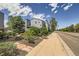Well-maintained light blue condo building with balconies, lush landscaping, and walkway enhancing its curb appeal at 7665 E Eastman Ave # 106A, Denver, CO 80231