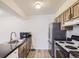 Functional kitchen with black countertops, stainless steel appliances, and plenty of cabinet storage at 7665 E Eastman Ave # 106A, Denver, CO 80231