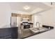 This kitchen features stainless steel appliances and a sleek black countertop at 7665 E Eastman Ave # 106A, Denver, CO 80231