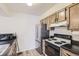 Functional kitchen with black countertops, stainless steel appliances, and plenty of cabinet storage at 7665 E Eastman Ave # 106A, Denver, CO 80231
