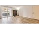 Bright living room featuring wood floors, a brick fireplace, and a sliding glass door to the outside at 7665 E Eastman Ave # 106A, Denver, CO 80231