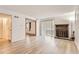 Bright living room featuring wood floors, a brick fireplace, and a sliding glass door to the outside at 7665 E Eastman Ave # 106A, Denver, CO 80231