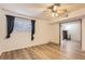 Living room features laminate flooring, a fan, and a charming fireplace at 7665 E Eastman Ave # 106A, Denver, CO 80231
