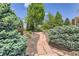 Manicured yard with decorative rock pathway, lush greenery, and trees offering a peaceful and inviting outdoor space at 7665 E Eastman Ave # 106A, Denver, CO 80231