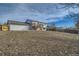 Large backyard with sloped terrain and wooden fence at 9749 Steele St, Thornton, CO 80229