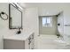 Clean bathroom with a gray tile shower and a white vanity at 9749 Steele St, Thornton, CO 80229