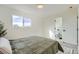 Light bedroom with green comforter and ensuite bathroom at 9749 Steele St, Thornton, CO 80229